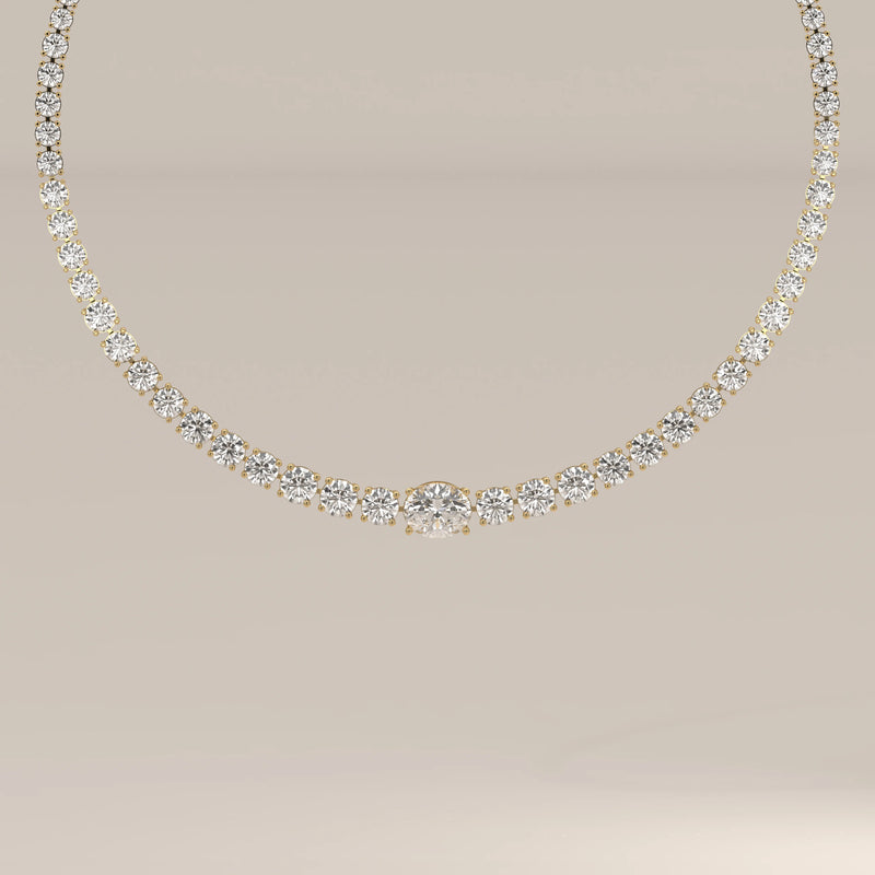 A graduated round lab grown diamond tennis necklace in yellow gold, shown from the front.