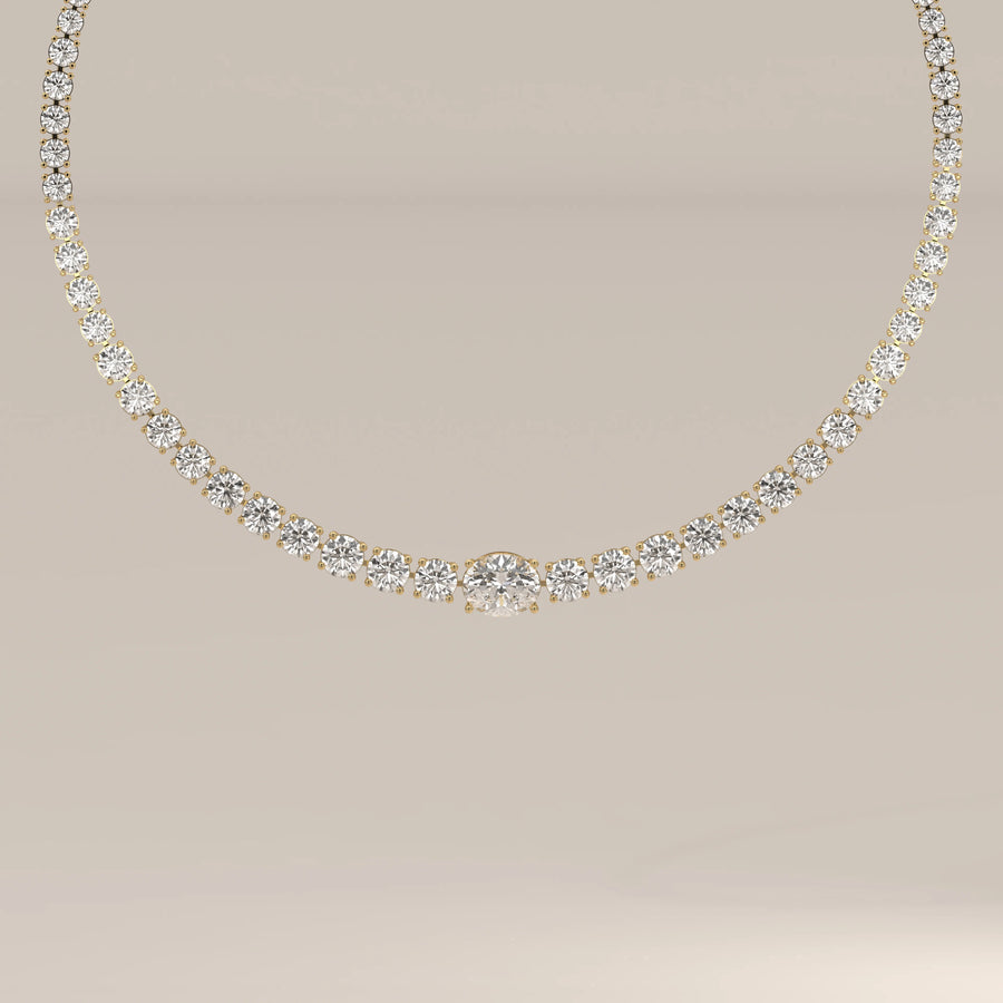 A graduated round lab grown diamond tennis necklace in yellow gold, shown from the front.