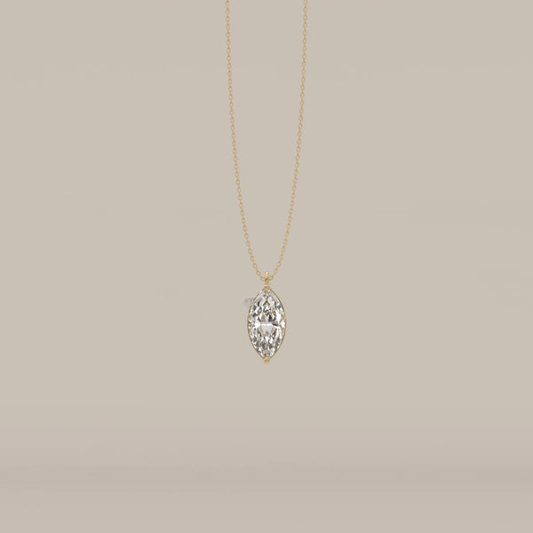 A delicate gold chain necklace with a large marquise-cut diamond pendant.