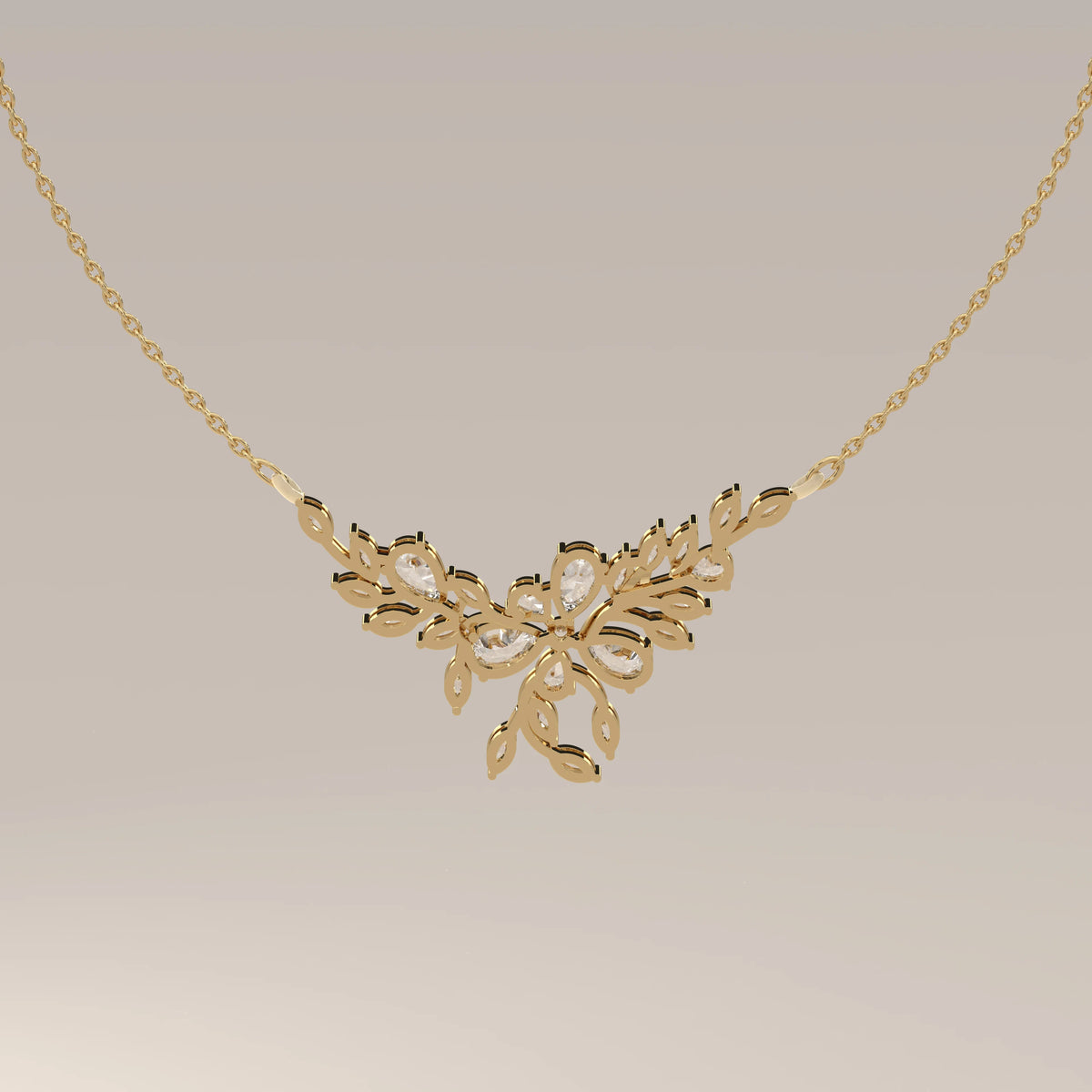 A marquise and pear lab grown diamond leaf necklace in yellow gold, photographed head-on.