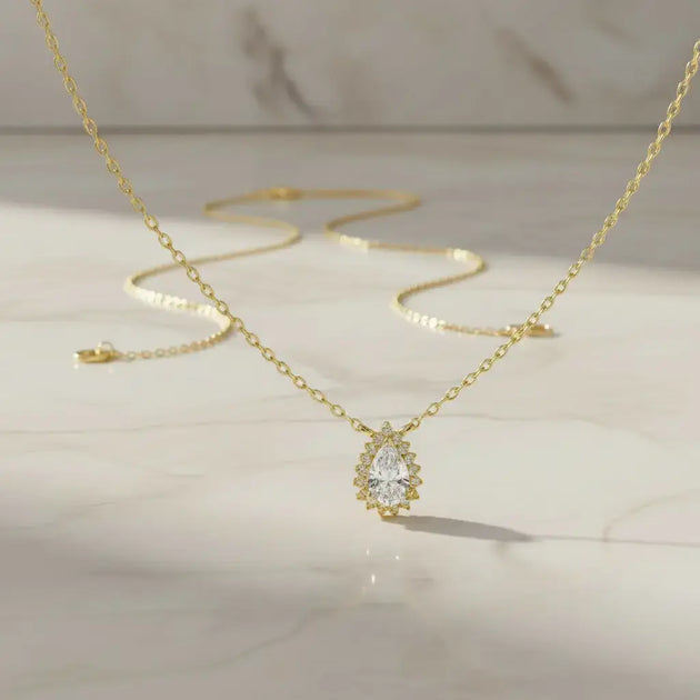 Flat Lay: Pear Cut Diamond Necklace with Halo Setting in 14k Yellow Gold - Lab Grown - Driona Jewels