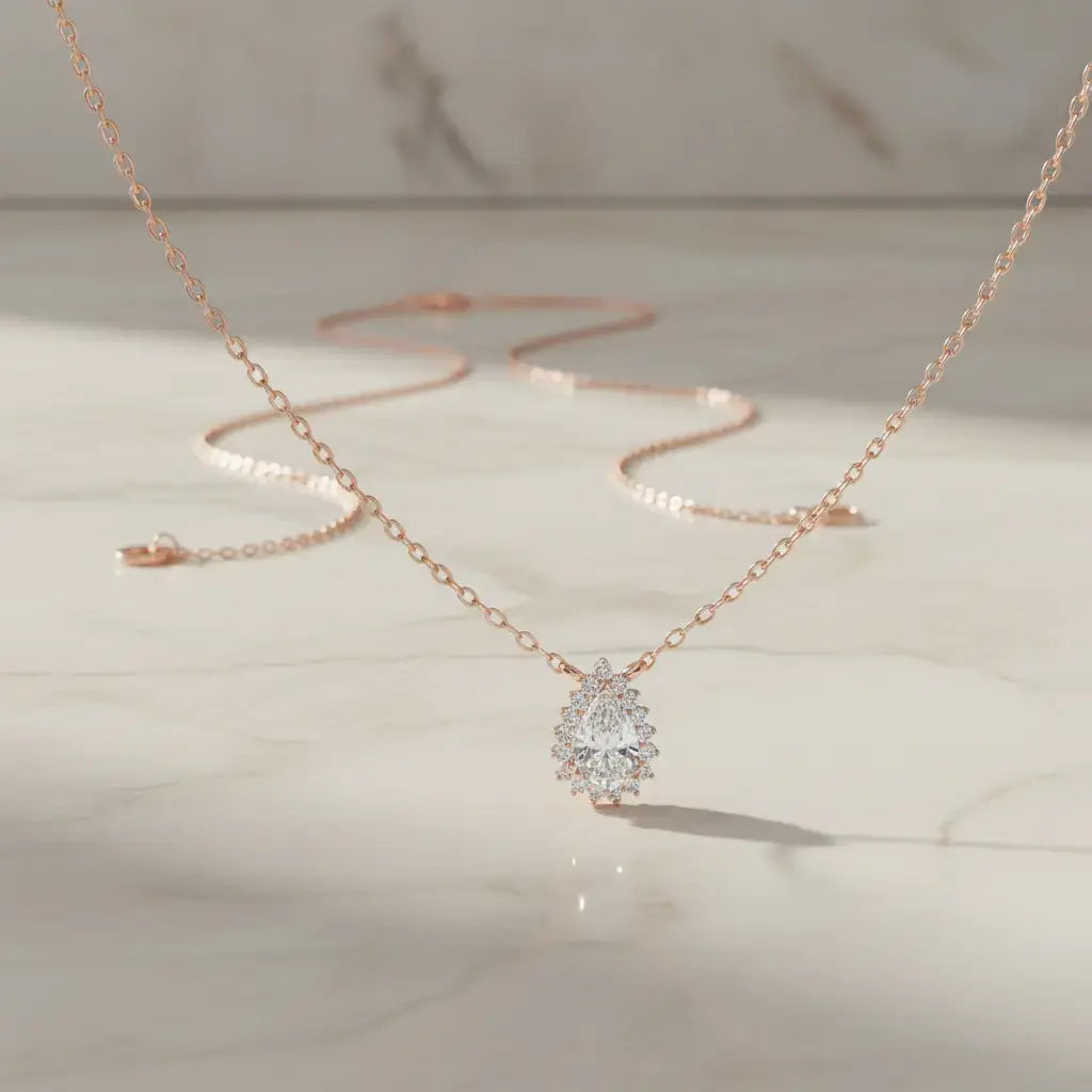 Flat Lay: Pear Cut Diamond Necklace with Solitaire Setting in 14k Rose Gold - Lab Grown - Driona Jewels