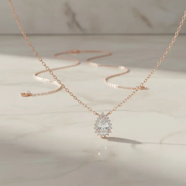 Flat Lay: Pear Cut Diamond Necklace with Solitaire Setting in 14k Rose Gold - Lab Grown - Driona Jewels