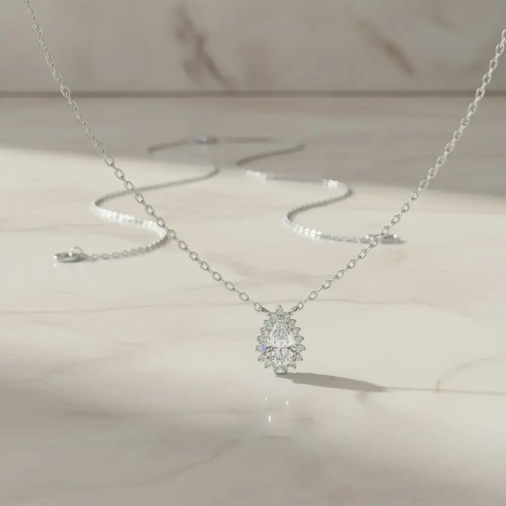 Flat Lay: Pear Cut Diamond Necklace with Solitaire Setting in 14k White Gold - Lab Grown - Driona Jewels