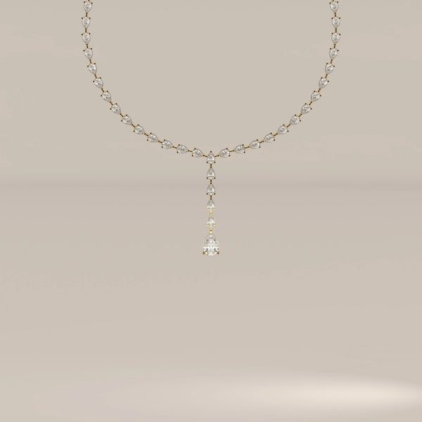A pear shape lab grown diamond drop necklace in yellow gold, shown from the front.