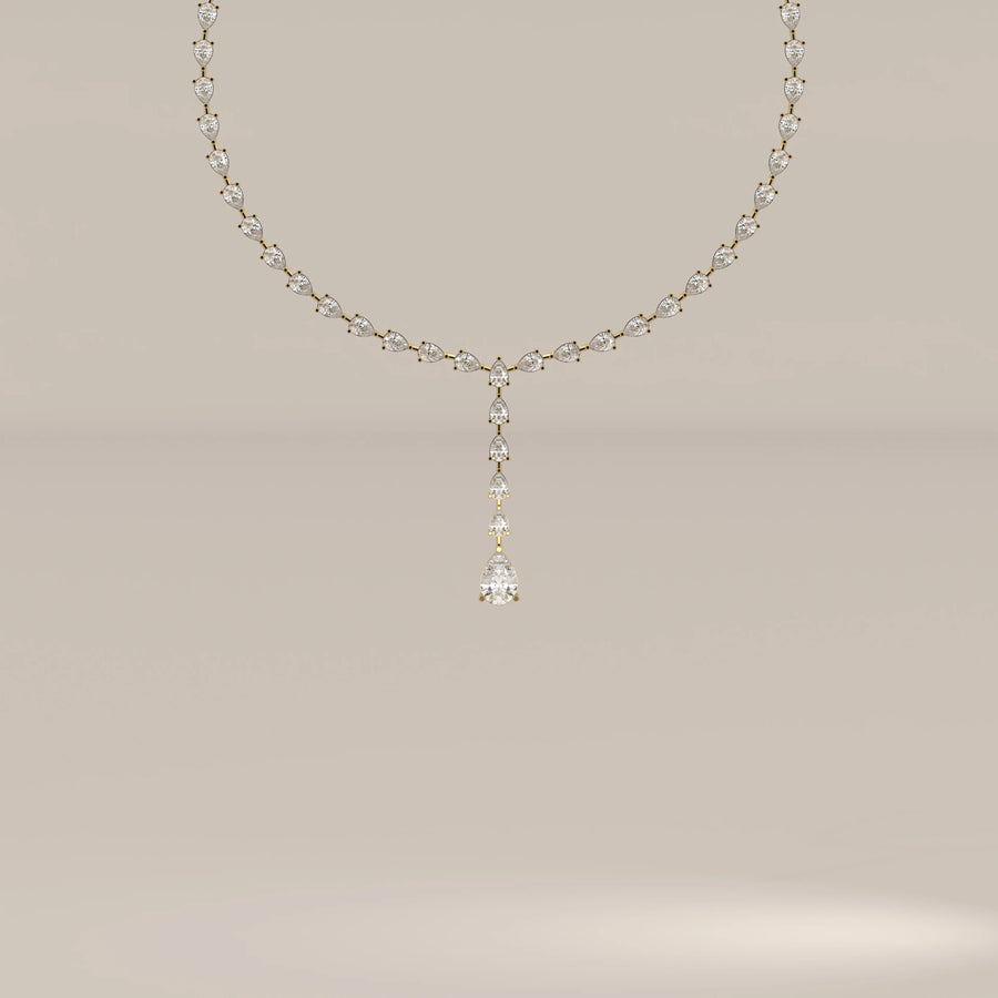 A pear shape lab grown diamond drop necklace in yellow gold, shown from the front.