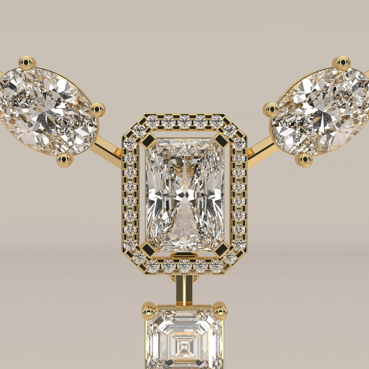 An emerald cut halo y-drop lab grown diamond necklace in yellow gold, front view on a plain background.