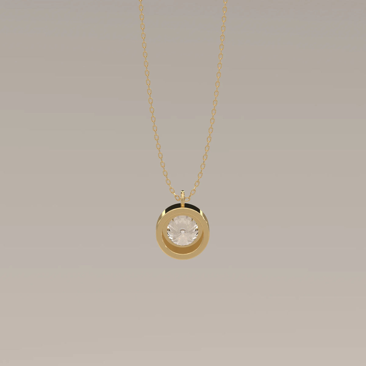 A circular gold pendant with a clear stone on a gold chain.
