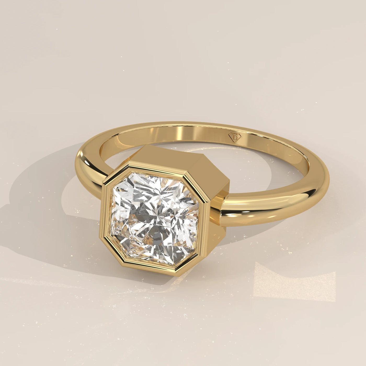 Yellow gold ring with a large, clear octagon-cut diamond in a bezel setting.