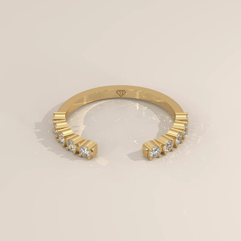 Yellow gold open cuff ring with graduated round lab grown diamonds bar set along both arms, shown from the front.