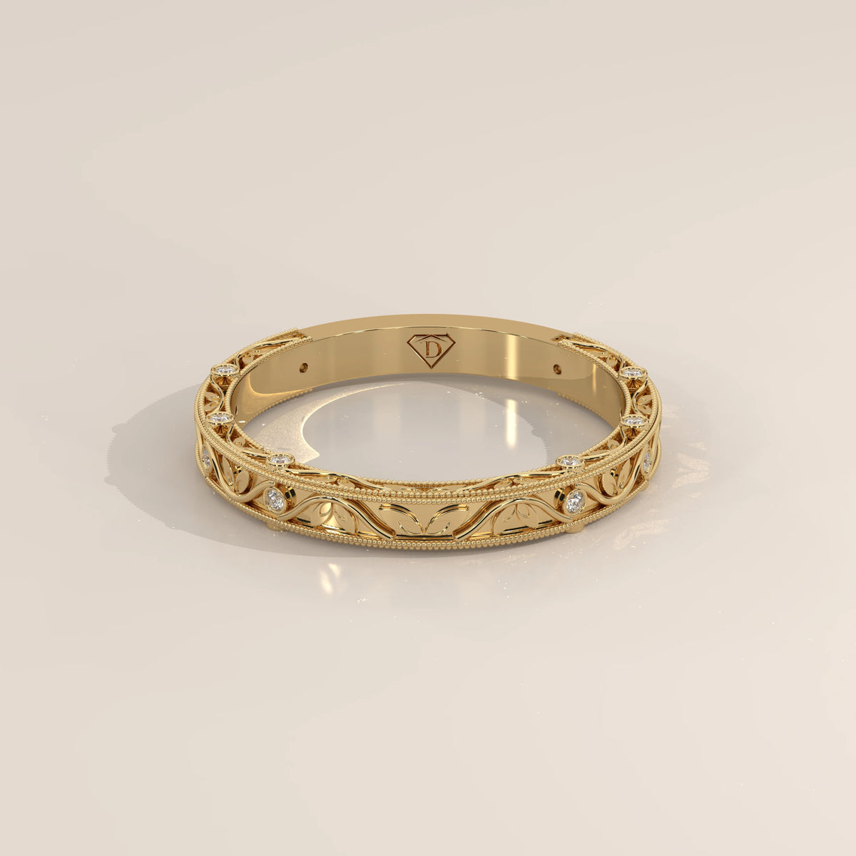 Ornate Filigree Engraved Band with Bezel Set Diamonds in yellow gold, shown at an angle.