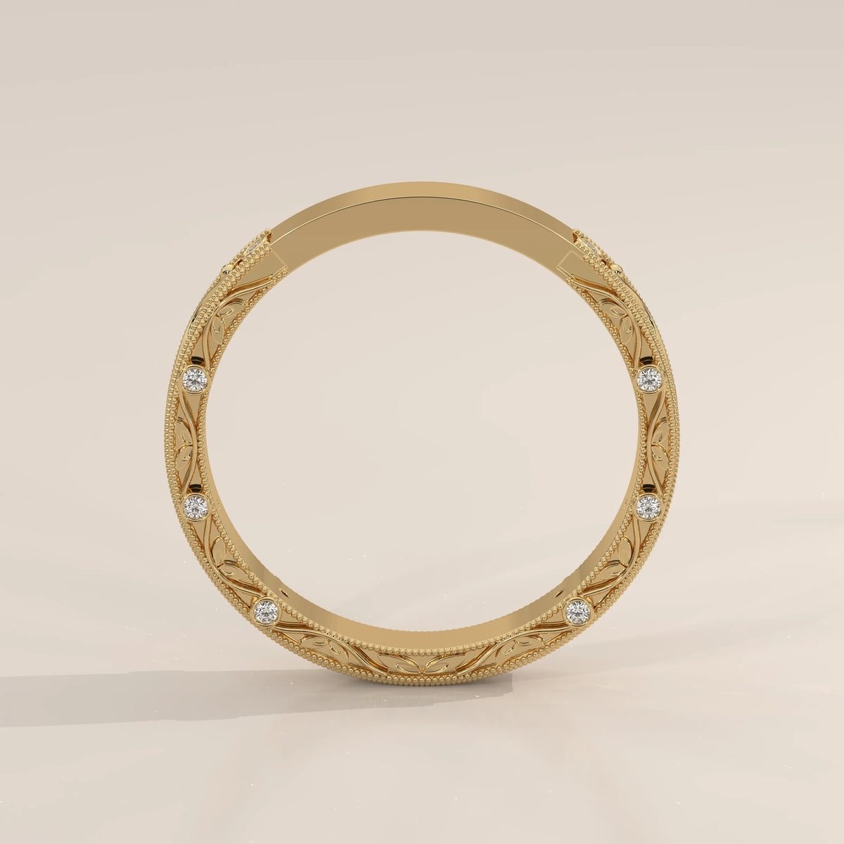 Ornate Filigree Engraved Band with Bezel Set Diamonds in yellow gold, front view on a plain background.