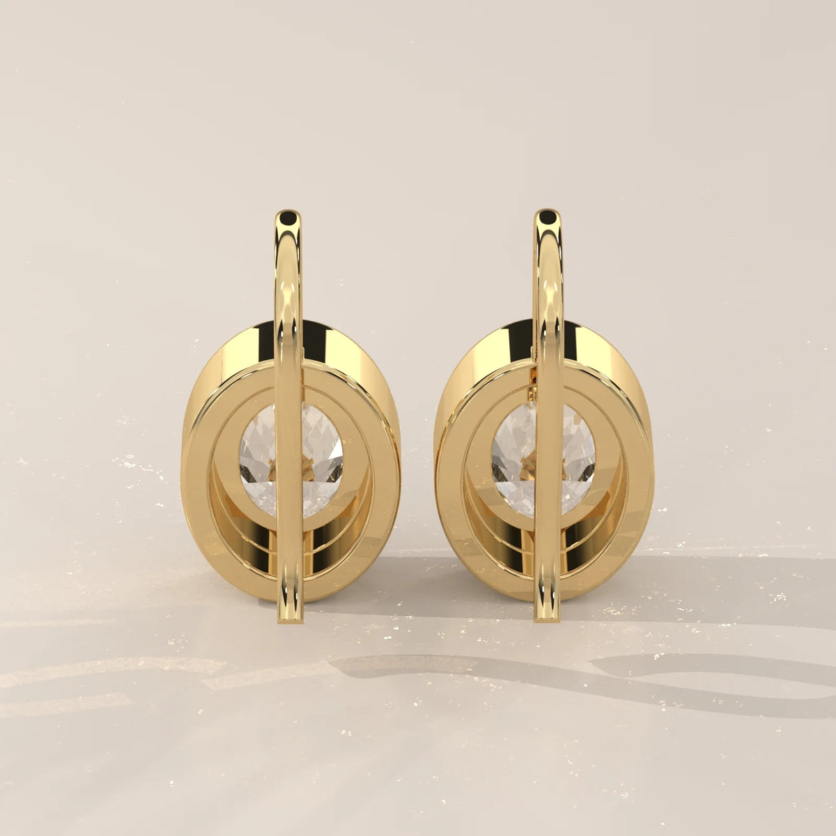 Oval Bezel Set Lab Grown Diamond Drop Earrings on a Gold Hook in yellow gold, photographed head-on.