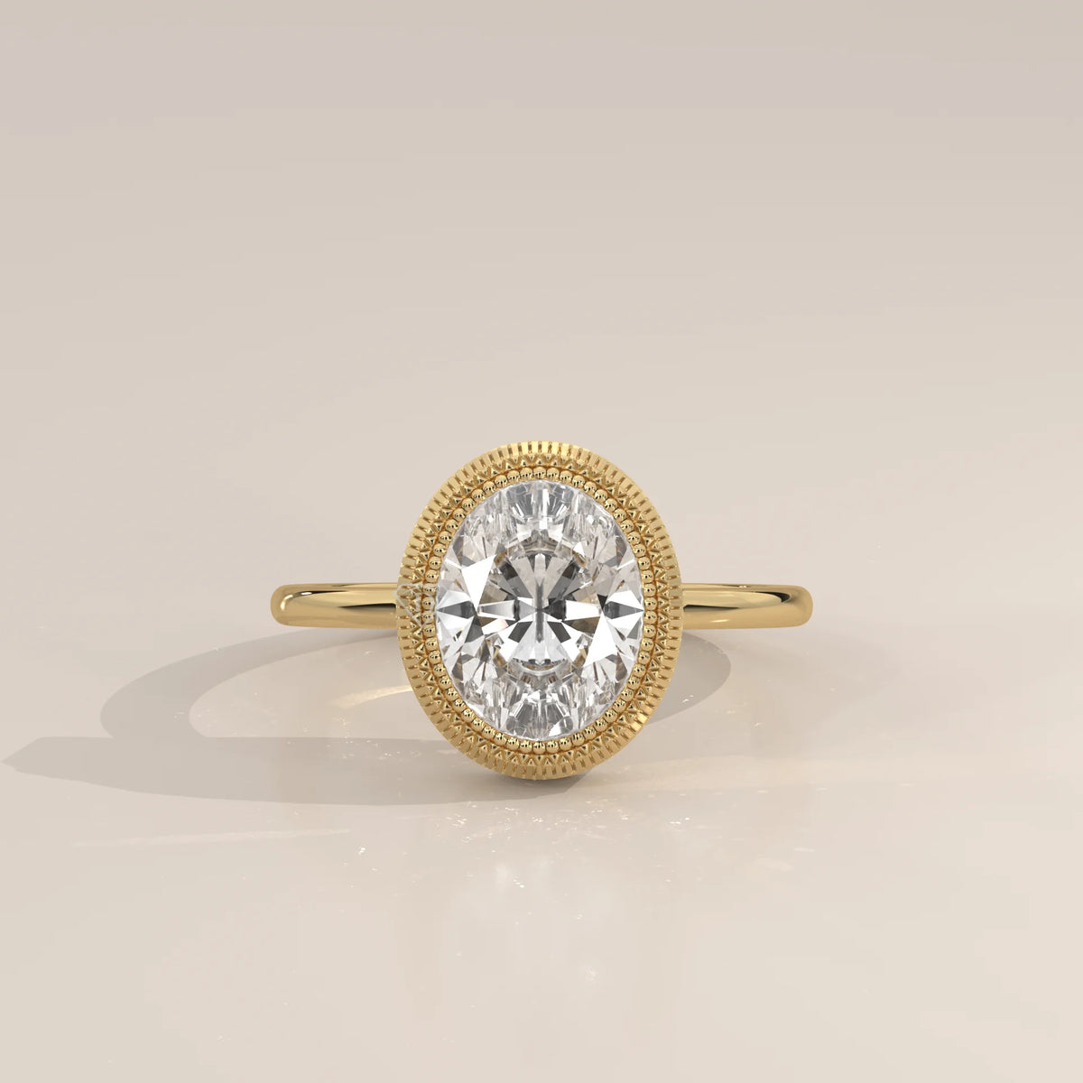 Oval Lab Grown Diamond Bezel Solitaire with Coin Edge Rim in yellow gold, photographed head-on.