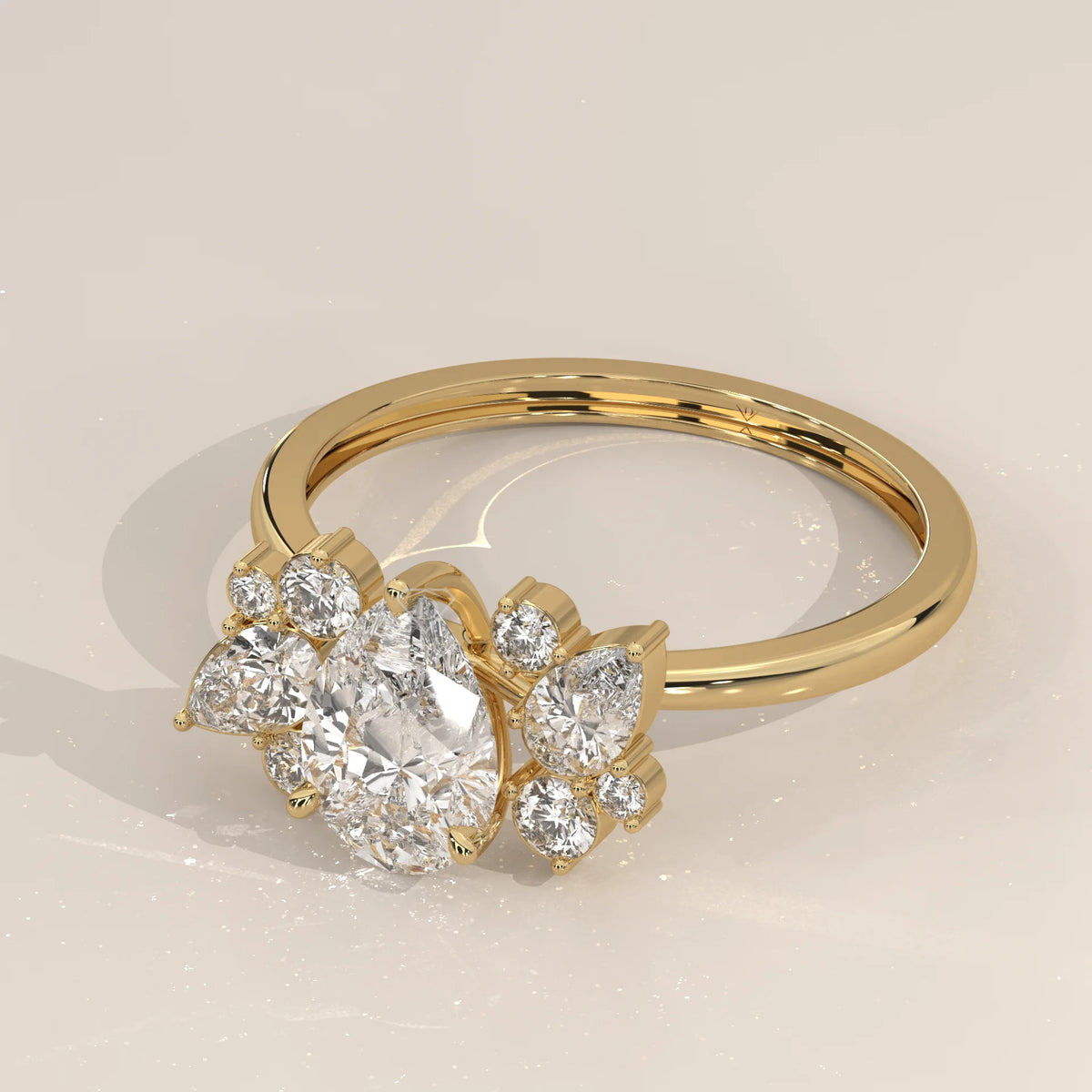 Pear Lab Grown Diamond Ring with Scattered Pear and Round Cluster in yellow gold, shown at an angle.