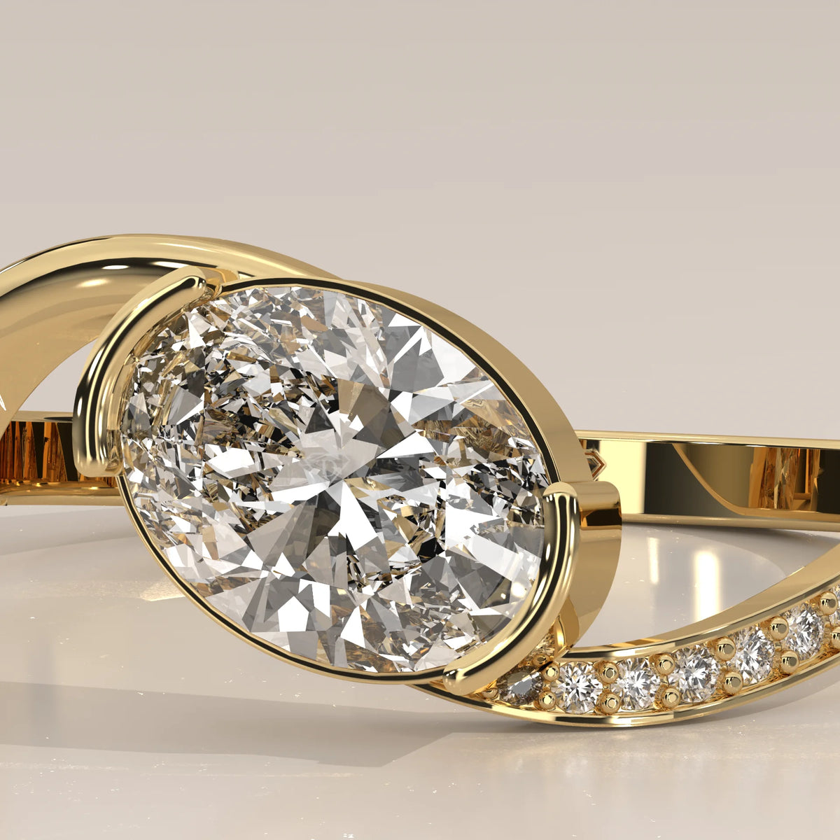 Oval Lab Grown Diamond Bypass Ring with Half Bezel and Pave Shoulder in yellow gold, photographed at a three-quarter angle.