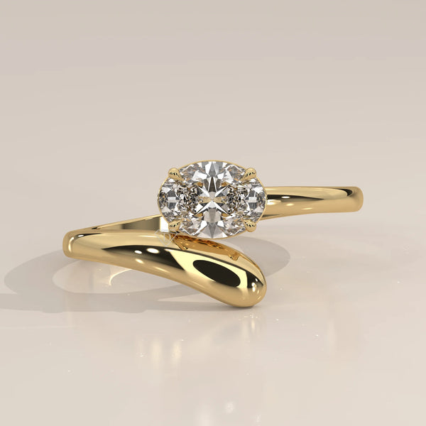 East West Oval Lab Grown Diamond Bypass Ring with Teardrop End in yellow gold, shown from the front.