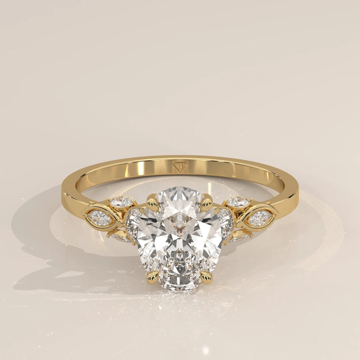 Gold ring with an oval-shaped diamond and leaf-like accents.