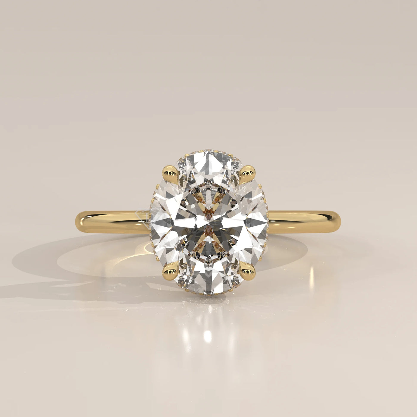 Oval cut diamond engagement ring with a paved band in yellow gold.
