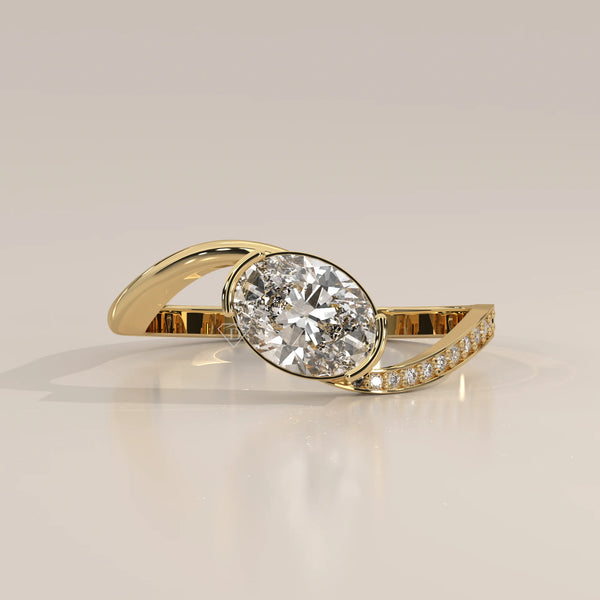 Oval Lab Grown Diamond Bypass Ring with Half Bezel and Pave Shoulder in yellow gold, shown from the front.