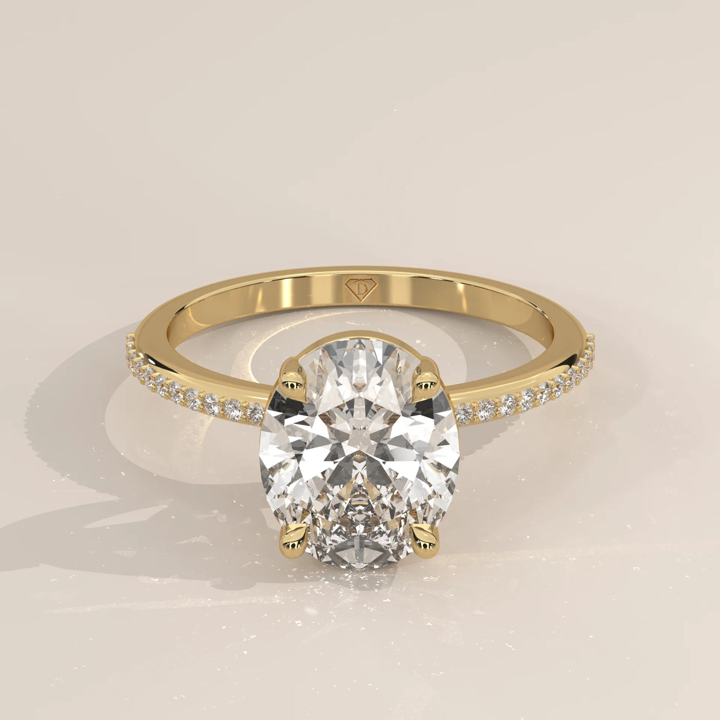 Oval cut diamond engagement ring with a paved band in yellow gold.