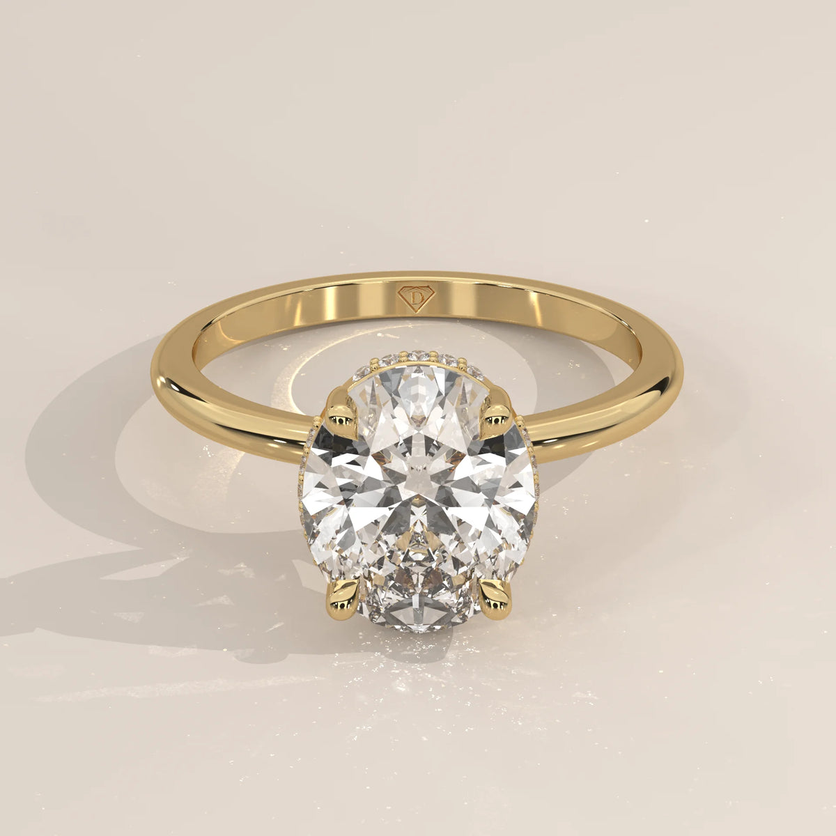 Oval cut diamond engagement ring with a paved band in yellow gold.