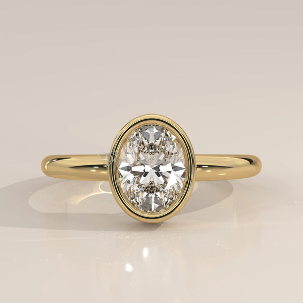 Oval cut diamond engagement ring with a paved band in yellow gold.