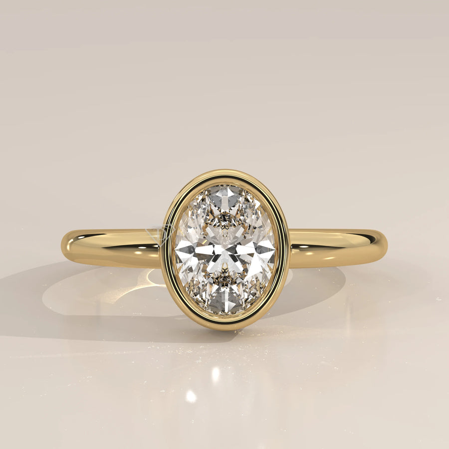 Oval cut diamond engagement ring with a paved band in yellow gold.