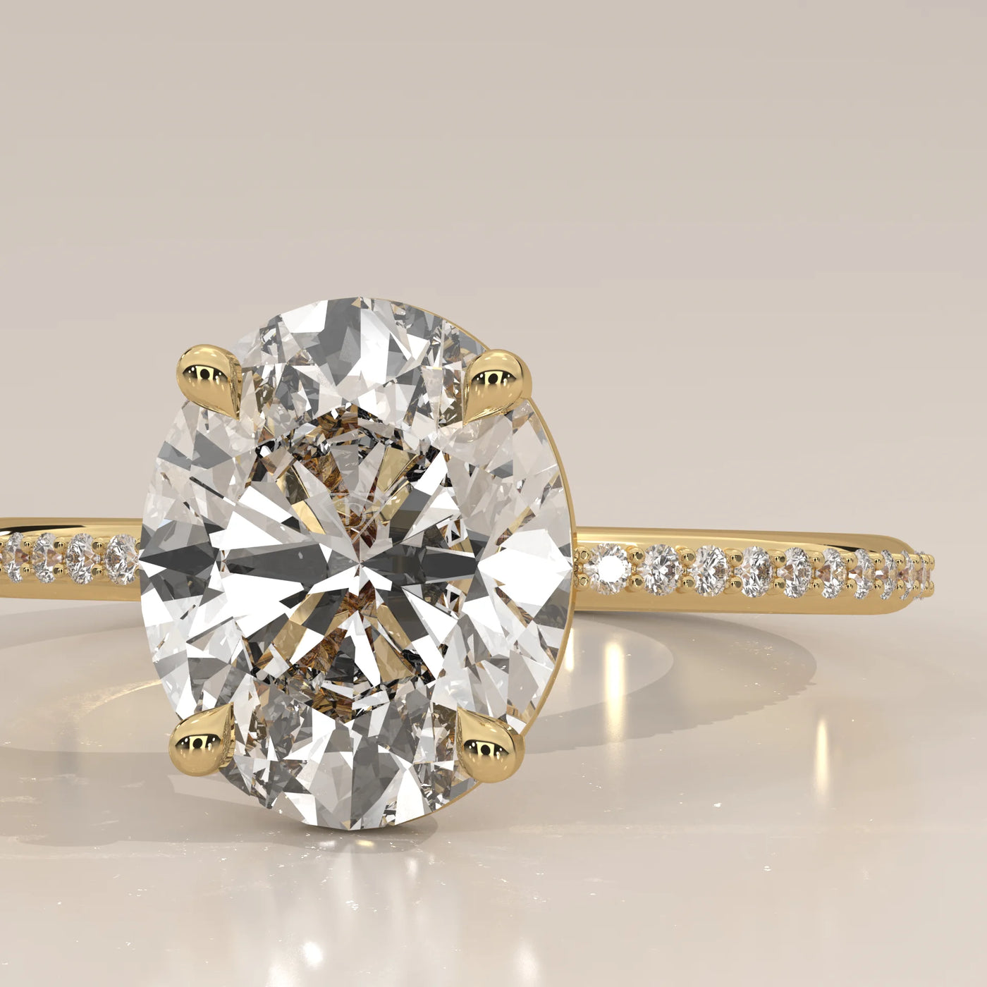 Oval cut diamond engagement ring with a paved band in yellow gold.