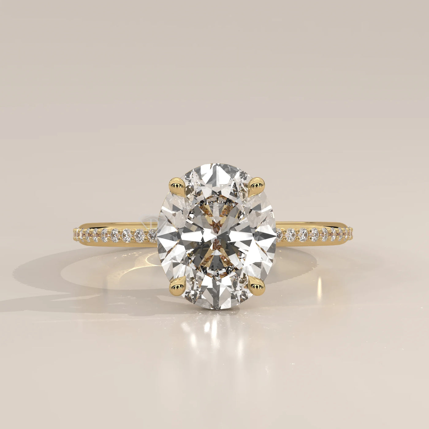 Oval cut diamond engagement ring with a paved band in yellow gold.
