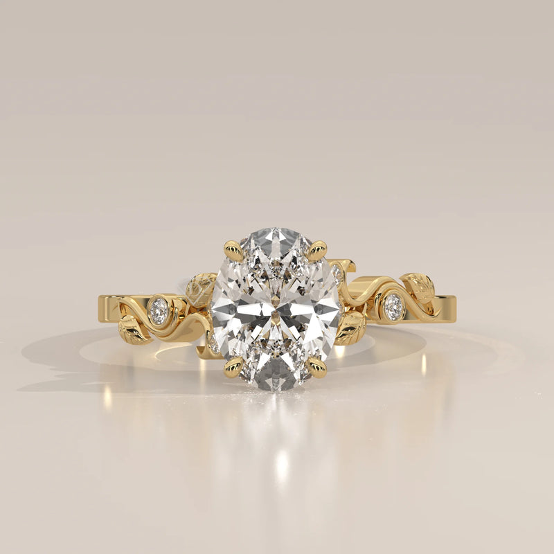 Gold ring with an oval-shaped diamond and leaf-like accents.