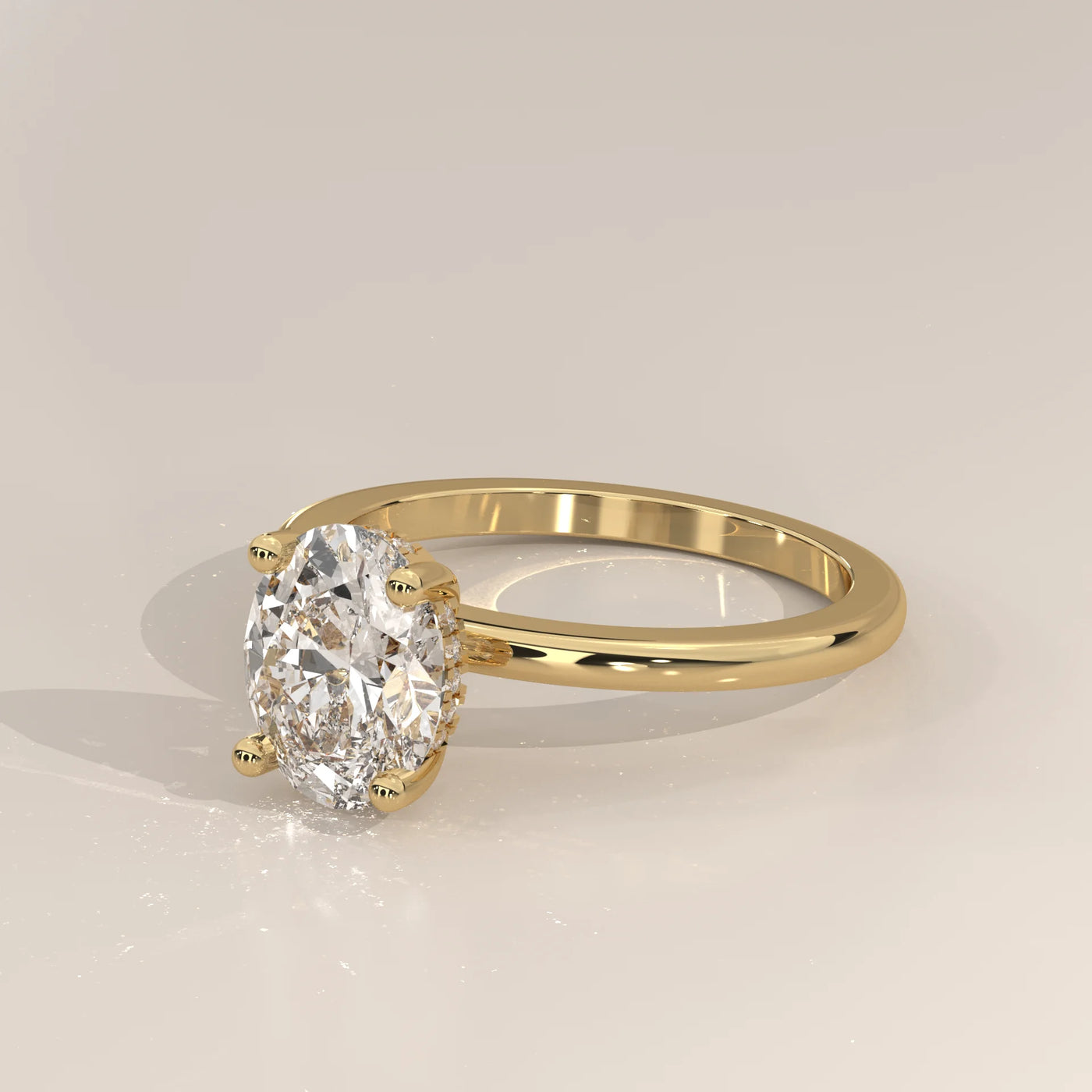 A yellow gold ring with an oval-cut diamond.