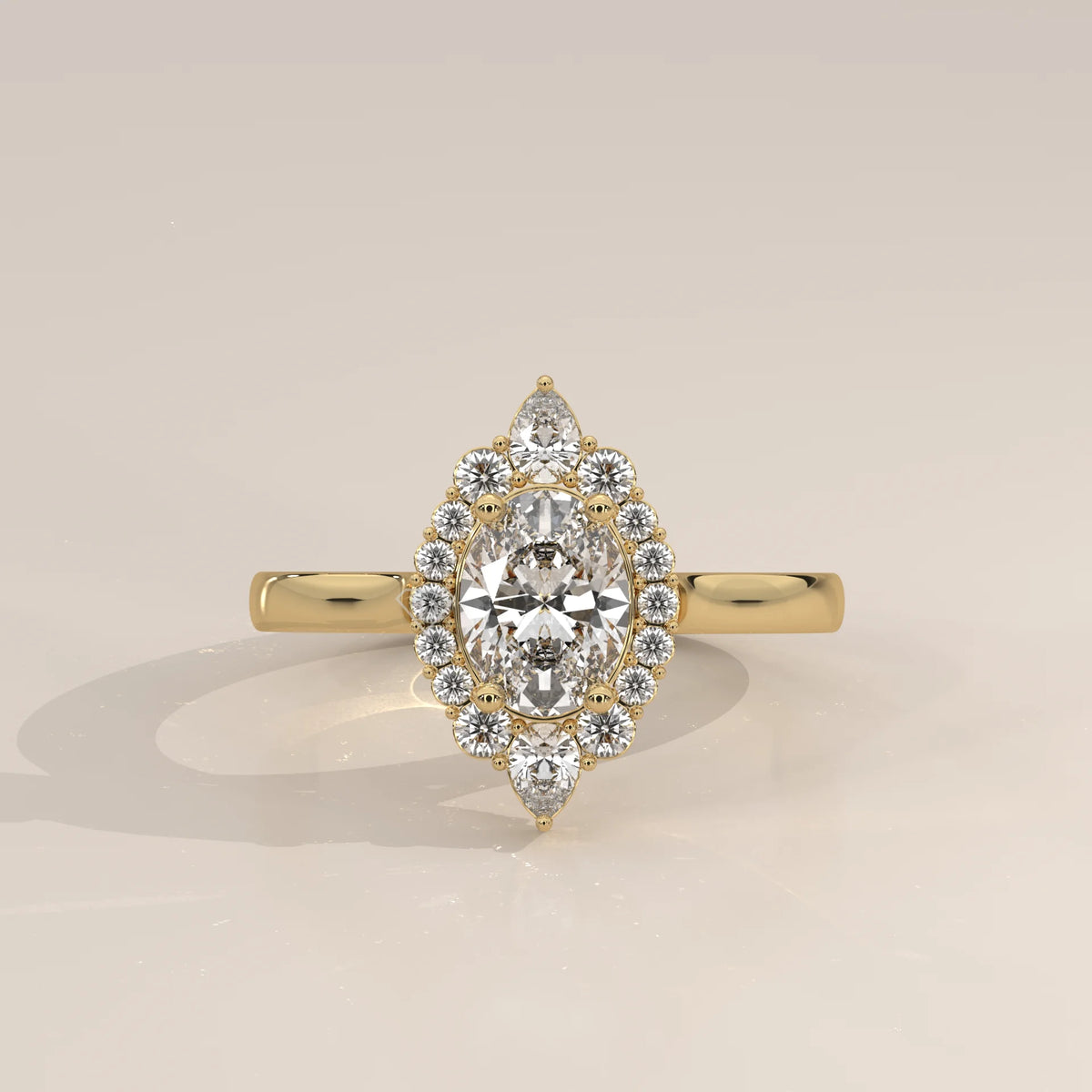 Oval Lab Grown Diamond Halo Ring with Pear Tips at Top and Base in yellow gold, shown from the front.