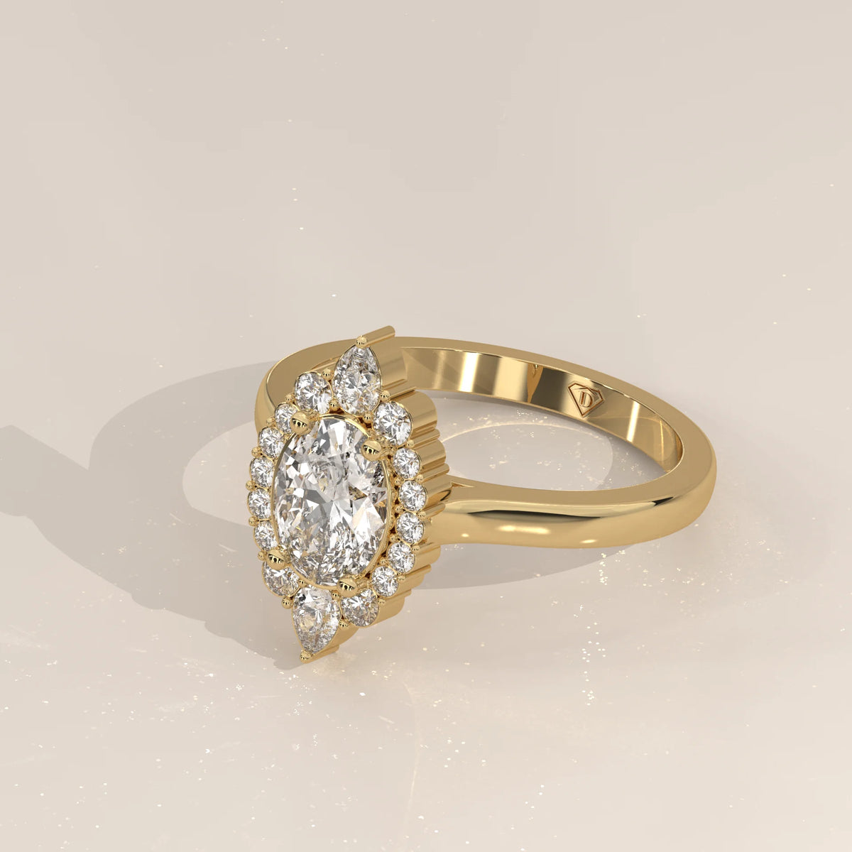 Oval Lab Grown Diamond Halo Ring with Pear Tips at Top and Base in yellow gold, photographed at a three-quarter angle.