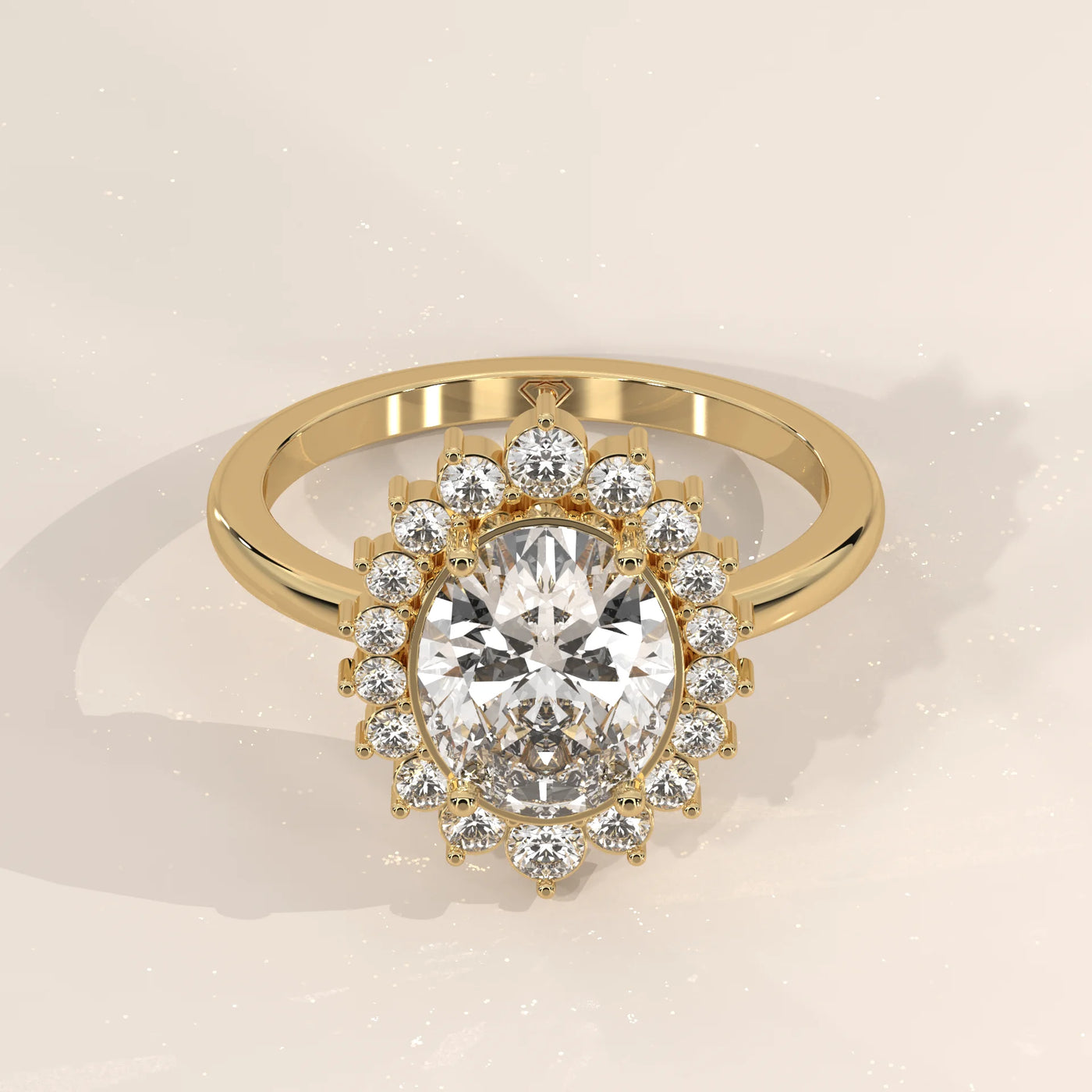 Oval diamond engagement ring with a halo of smaller diamonds in yellow gold.