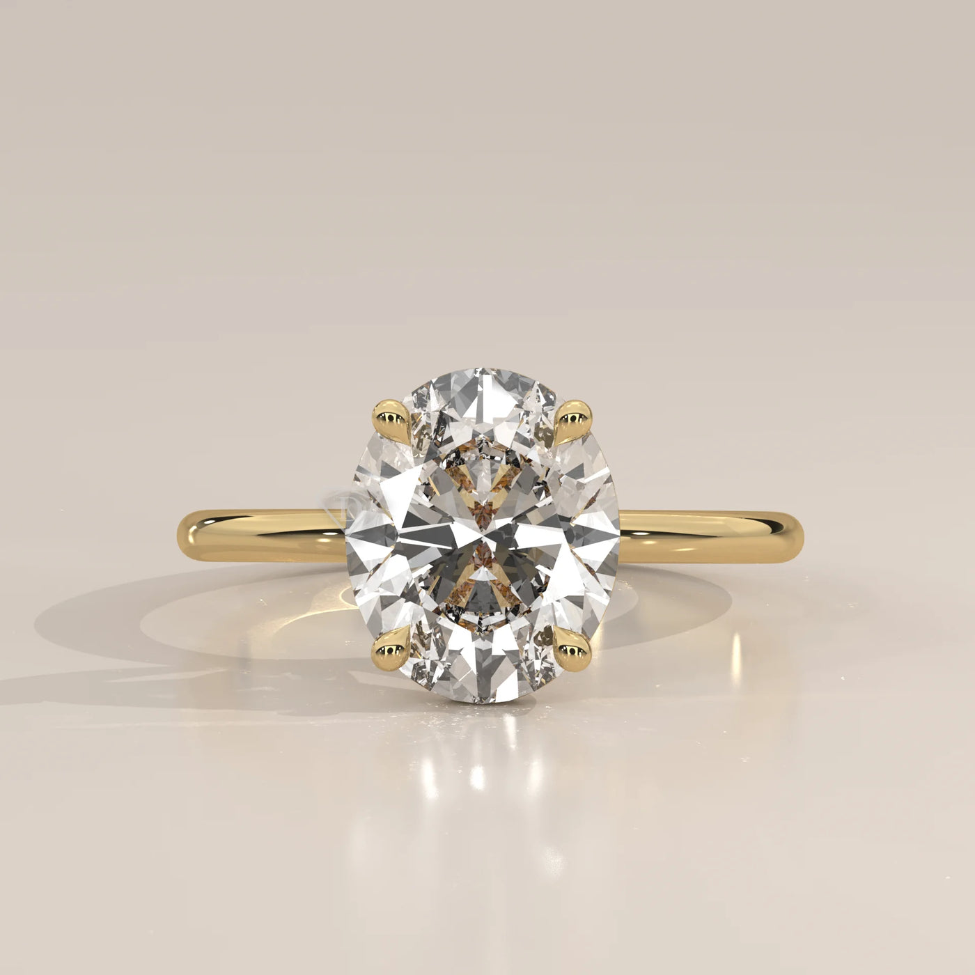 Oval diamond solitaire ring in 14k yellow gold.