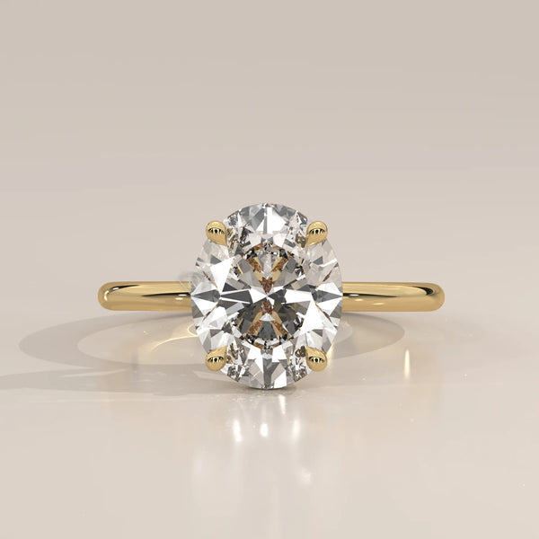 Oval diamond solitaire ring in 14k yellow gold.