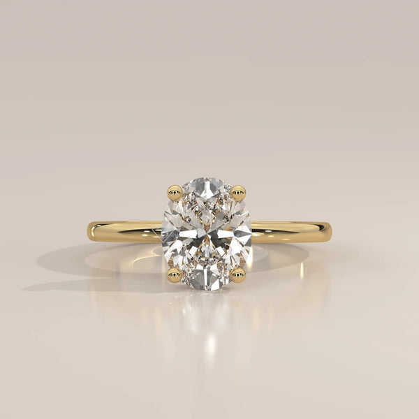 Oval Lab Grown Diamond Solitaire with Hidden Halo and Scroll Gallery in yellow gold, photographed head-on.