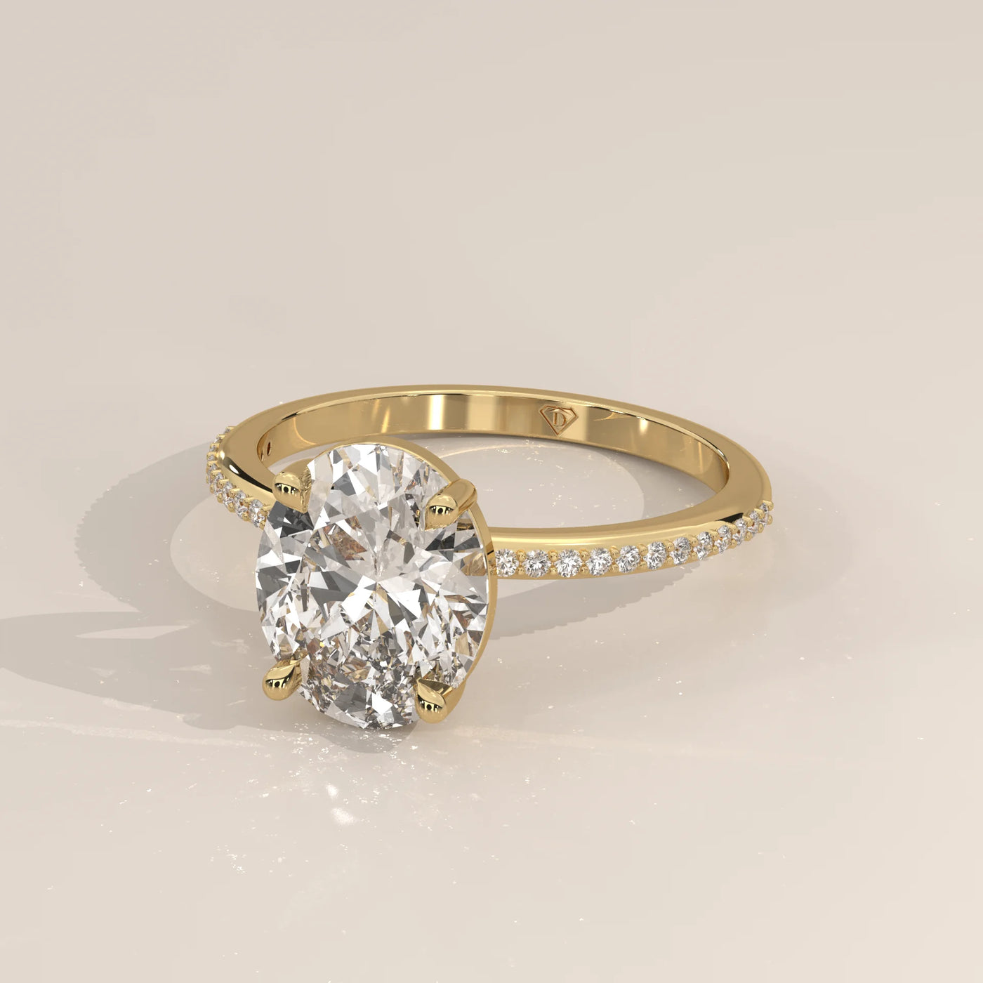 Oval cut diamond engagement ring with pav	act stones in yellow gold.