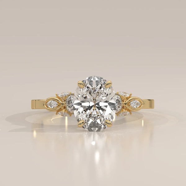 Oval diamond engagement ring with floral accents in 18k yellow gold.