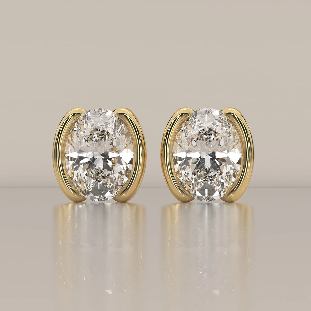 Oval Half Bezel Lab Grown Diamond Stud Earrings with Curved Bars in yellow gold, shown from the front.