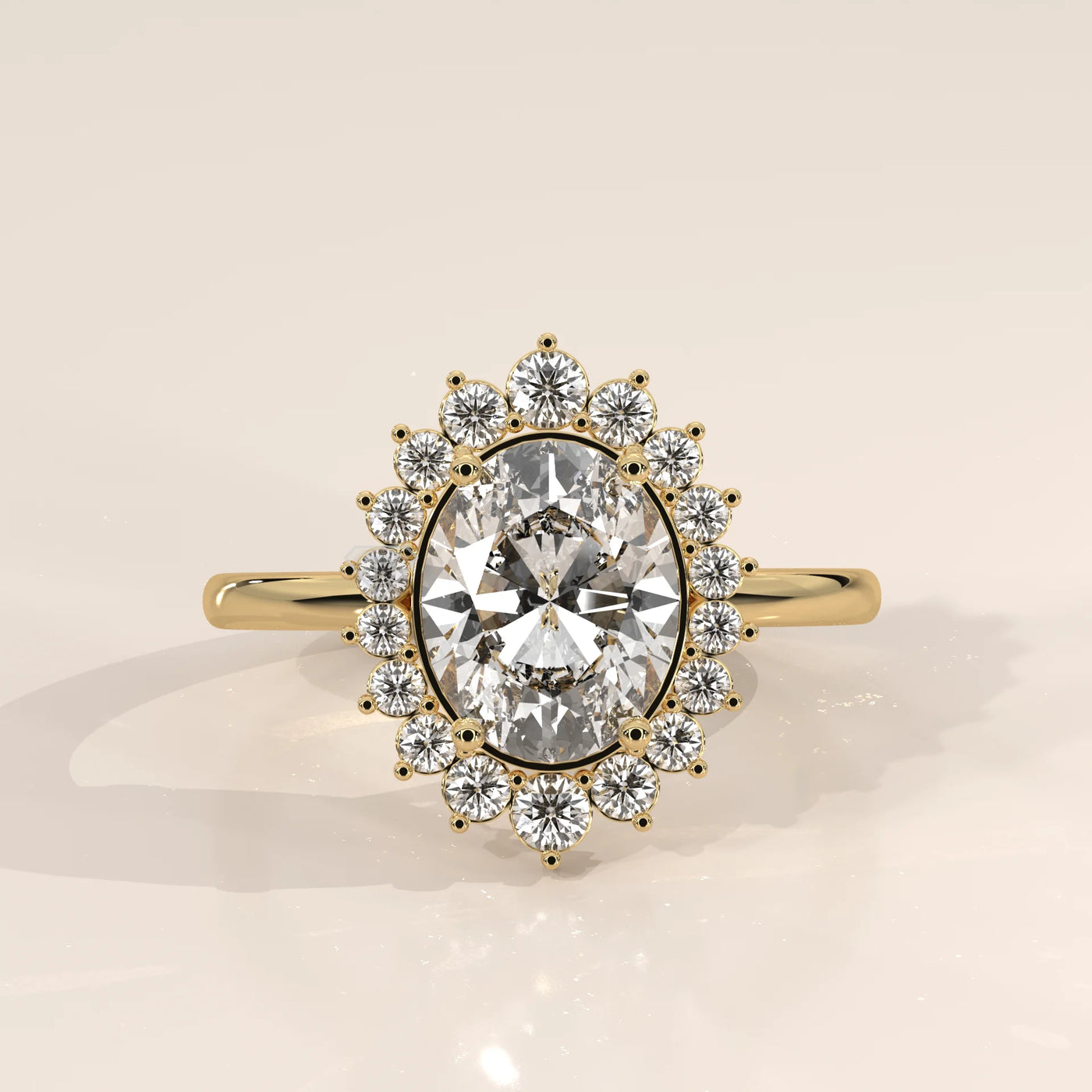 Oval diamond engagement ring with a halo of smaller diamonds, set in 14k gold.