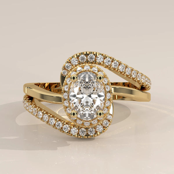Oval Lab Grown Diamond Halo Ring with Swirling Pave Bypass in yellow gold, photographed head-on.