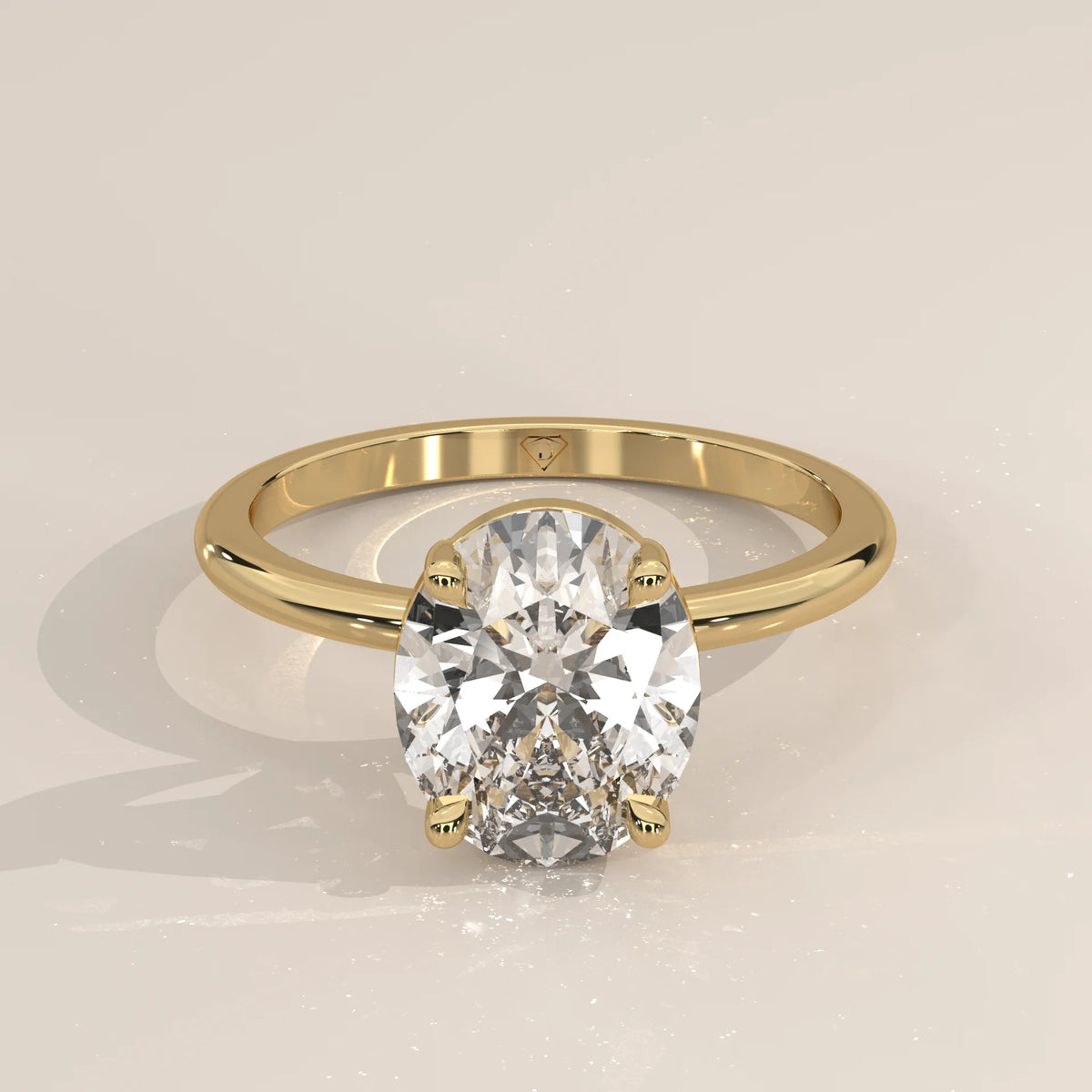 A classic oval diamond solitaire ring in 14k yellow gold.