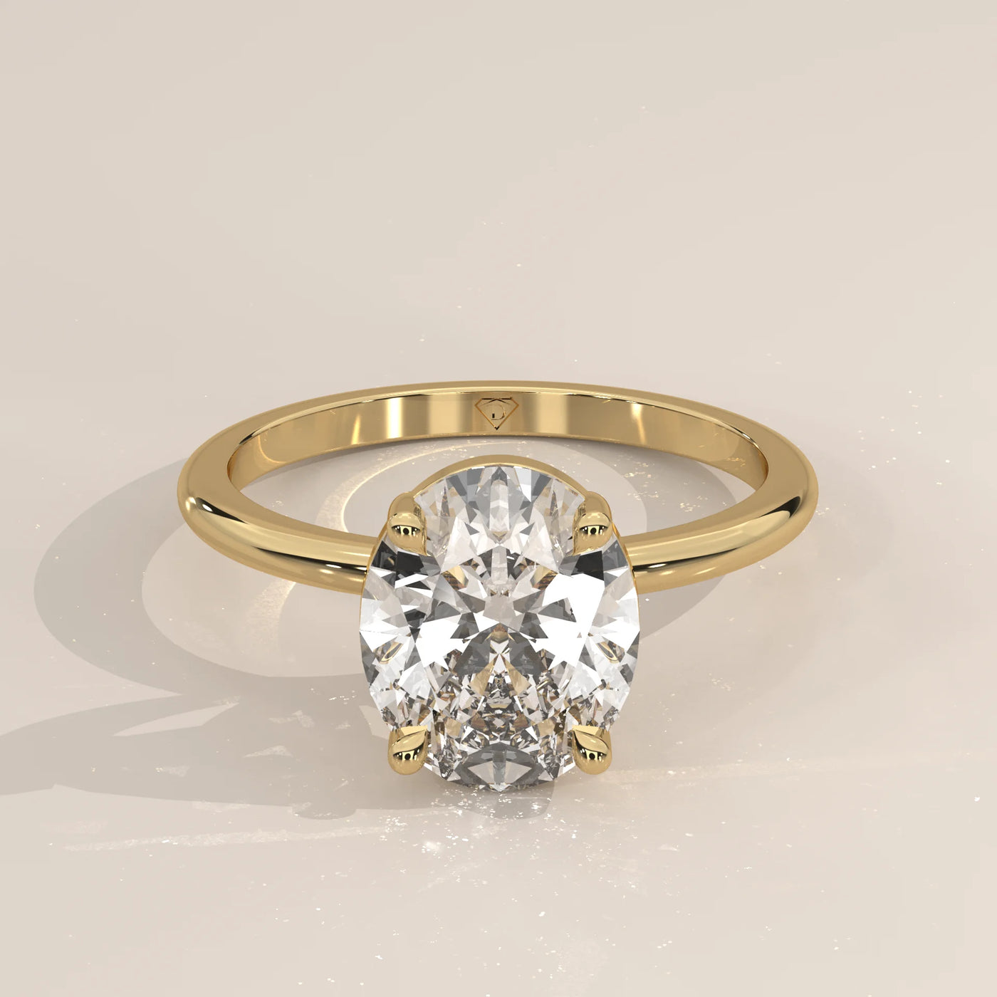 A classic oval diamond solitaire ring in 14k yellow gold.