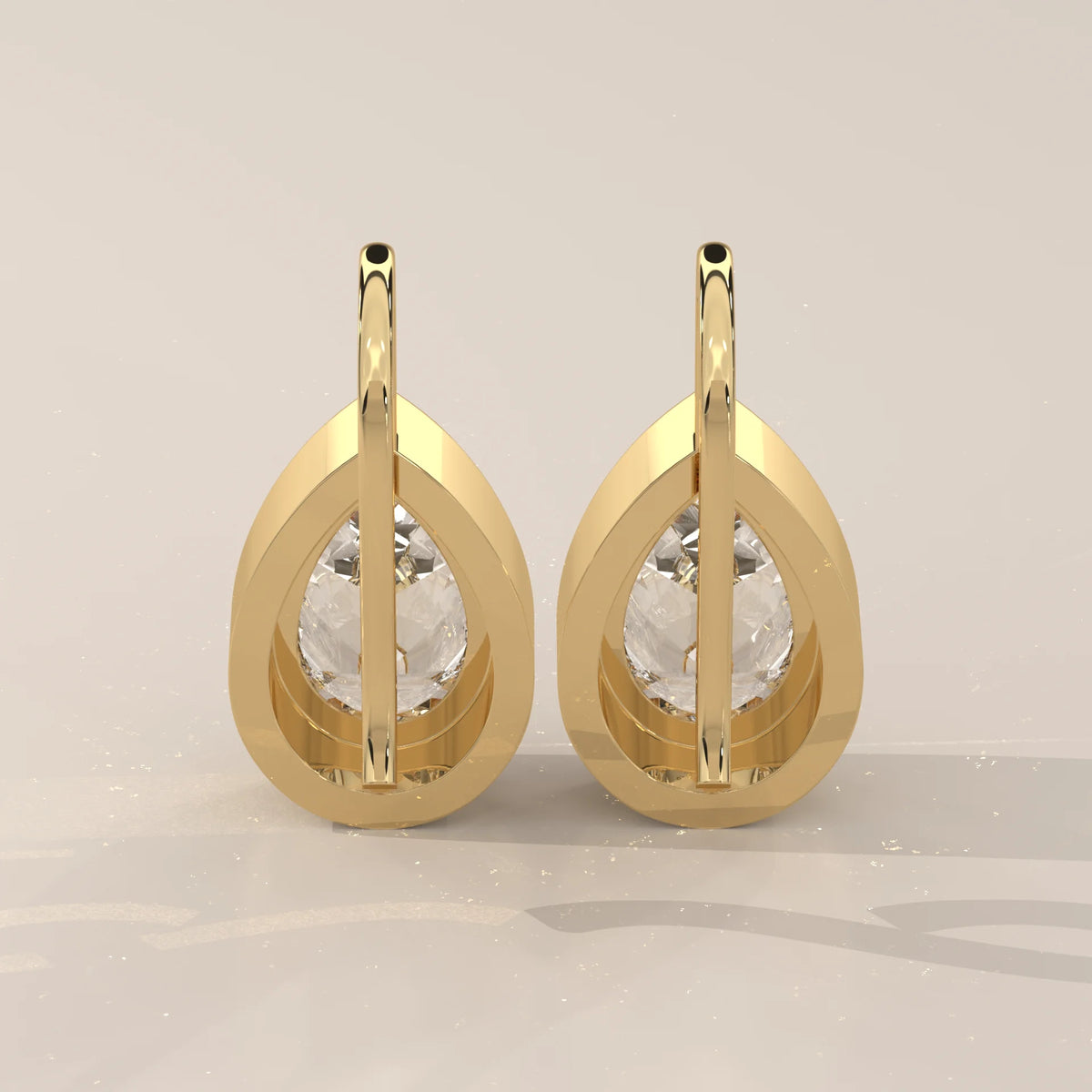Pear Bezel Lab Grown Diamond Drop Earrings on a Solid Gold Hook in yellow gold, shown at an angle.