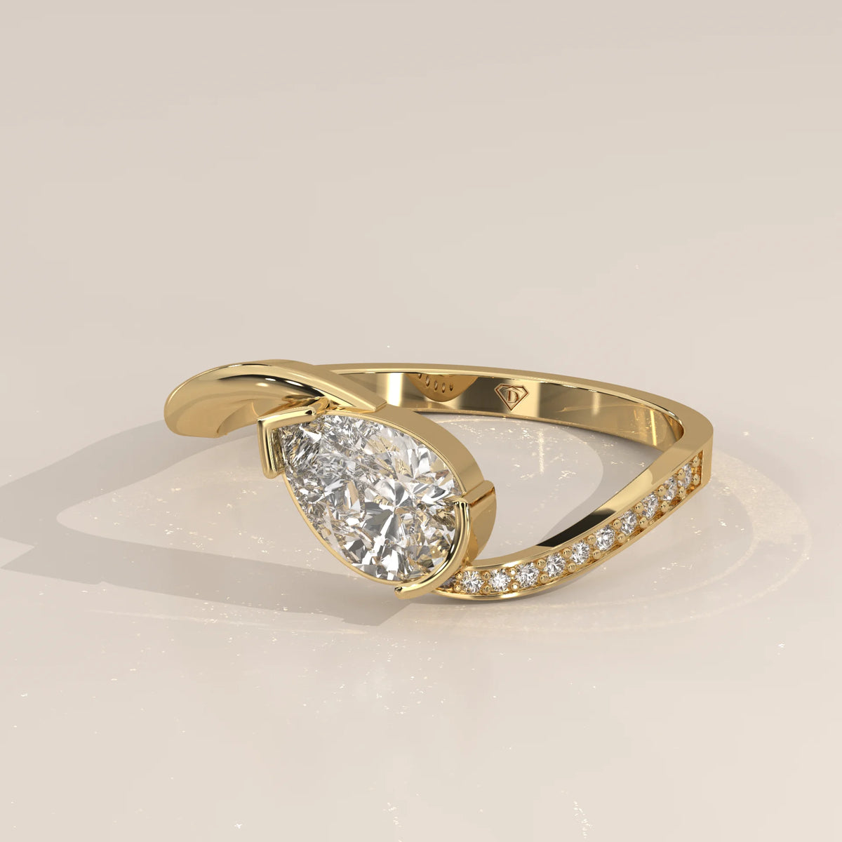 Pear Lab Grown Diamond Bypass Ring with Half Bezel and Pave Shoulder in yellow gold, photographed at a three-quarter angle.
