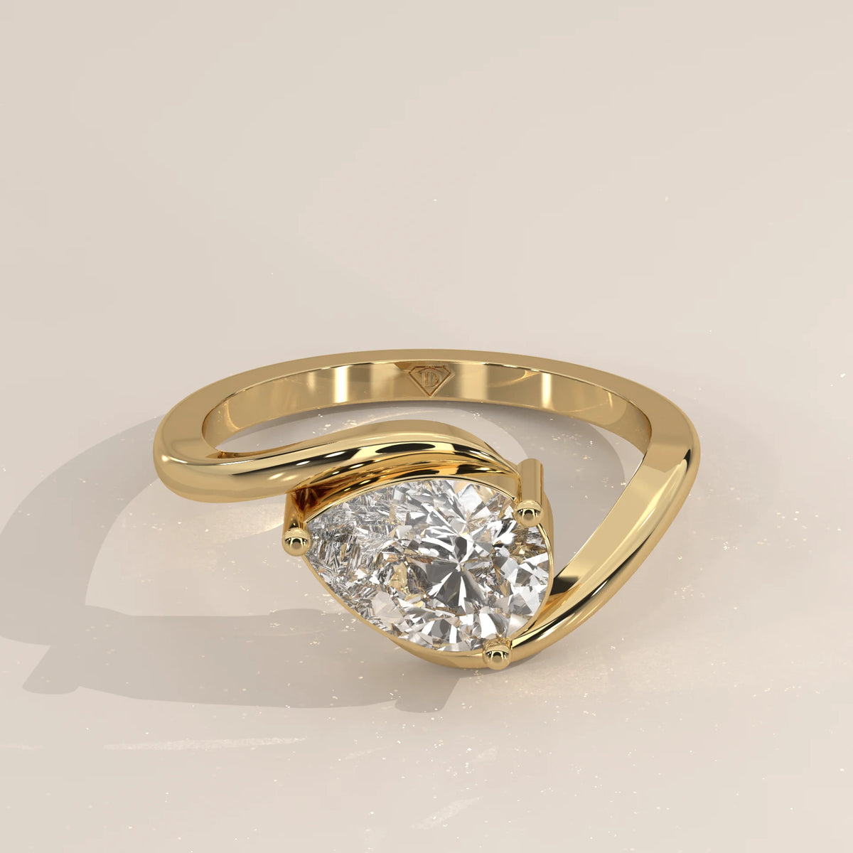 A 14k yellow gold ring with a pear-cut diamond.