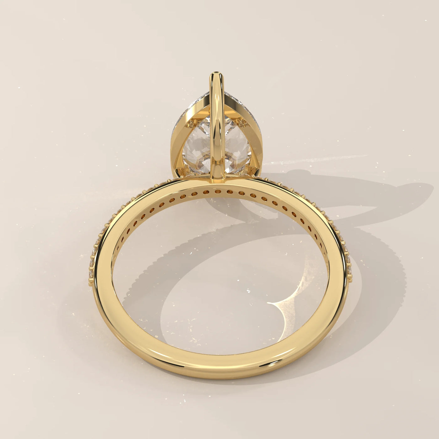 Yellow gold ring with a pear-cut diamond and pave band