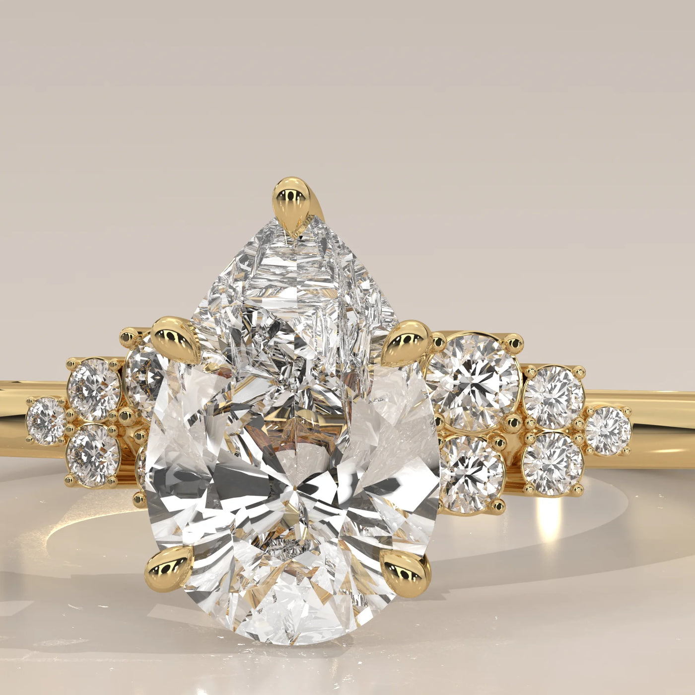 A delicate 14k gold ring featuring a pear-cut diamond with a cluster of smaller diamonds.